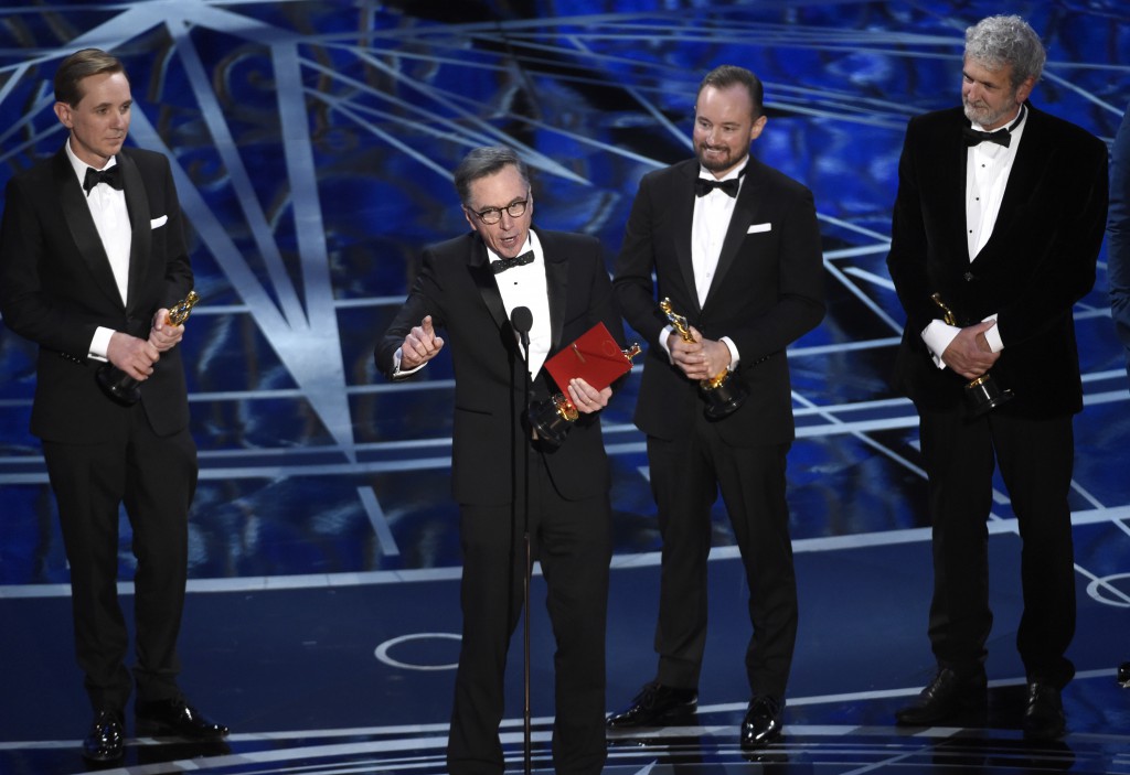 Robert Mackenzie, from left, Kevin O'Connell, Andy Wright, and Peter Grace accept the award for best sound mixing for "Hacksaw Ridge" at the Oscars on Sunday, Feb. 26, 2017, at the Dolby Theatre in Los Angeles. (Photo by Chris Pizzello/Invision/AP)