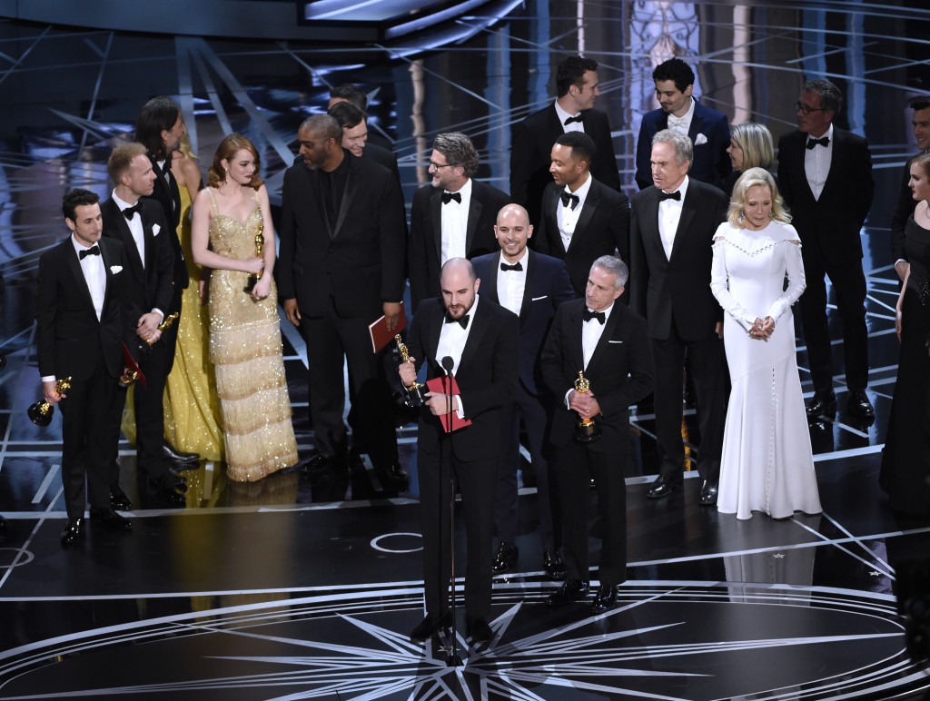 Jordan Horowitz, frente al centro, y el elenco de "La La Land" reciben por error el premio a la mejor película en los Oscar el domingo 26 de febrero de 2017 en el Teatro Dolby en Los Angeles. Momentos después se anunció que "Moonlight" fue la ganadora del premio a la mejor película. (Foto Chris Pizzello/Invision/AP)